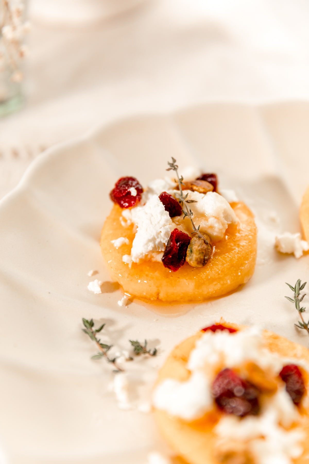 single polenta cake topped with goat cheese and honey