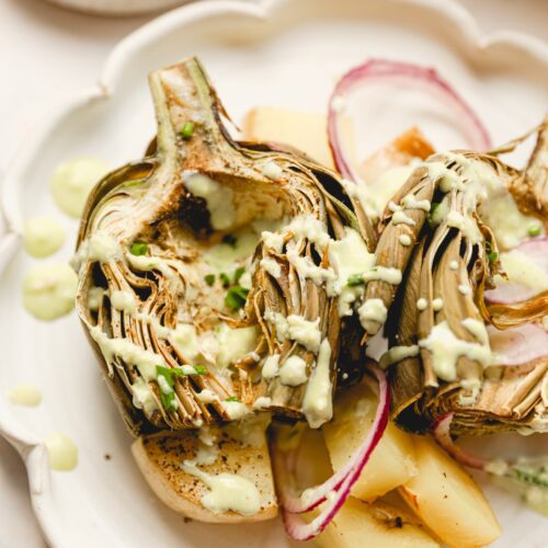 roasted artichoke halve with garlic parmesan sauce