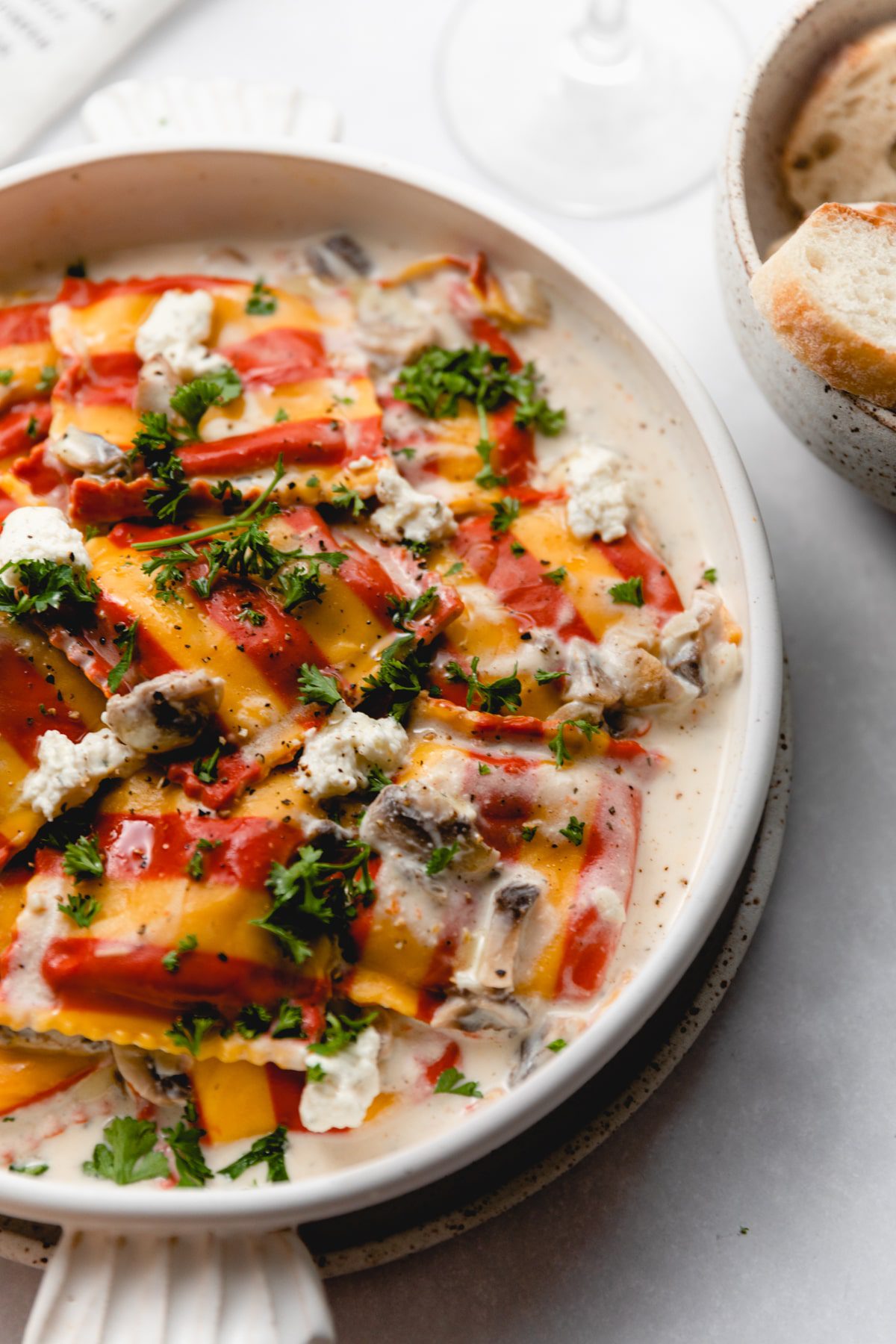 close up photograph of lobster ravioli sauce in a white bowl
