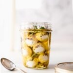jar of mozzarella pearls in infused olive oil