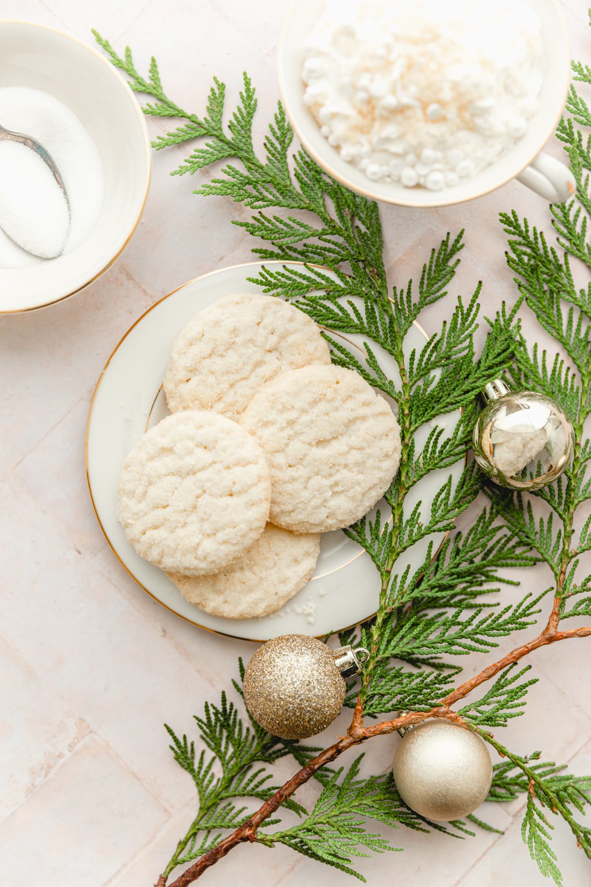 plate of sugar cookies with greenery garnish
