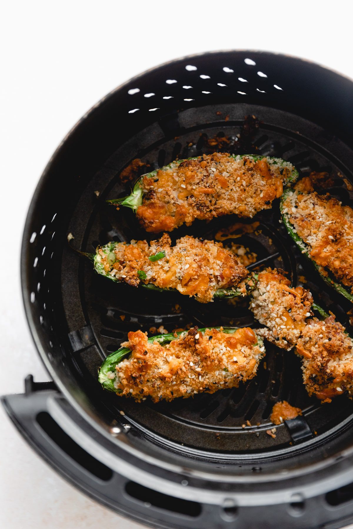 overhead photo of jalapeno poppers in the air fryer