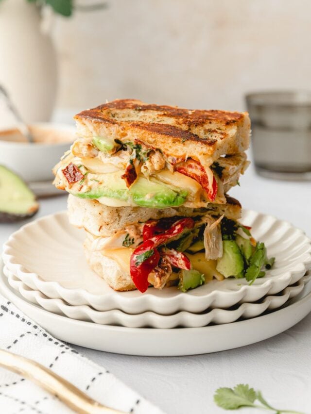 chipotle chicken avocado melt cut in half and stacked on top of each other. 