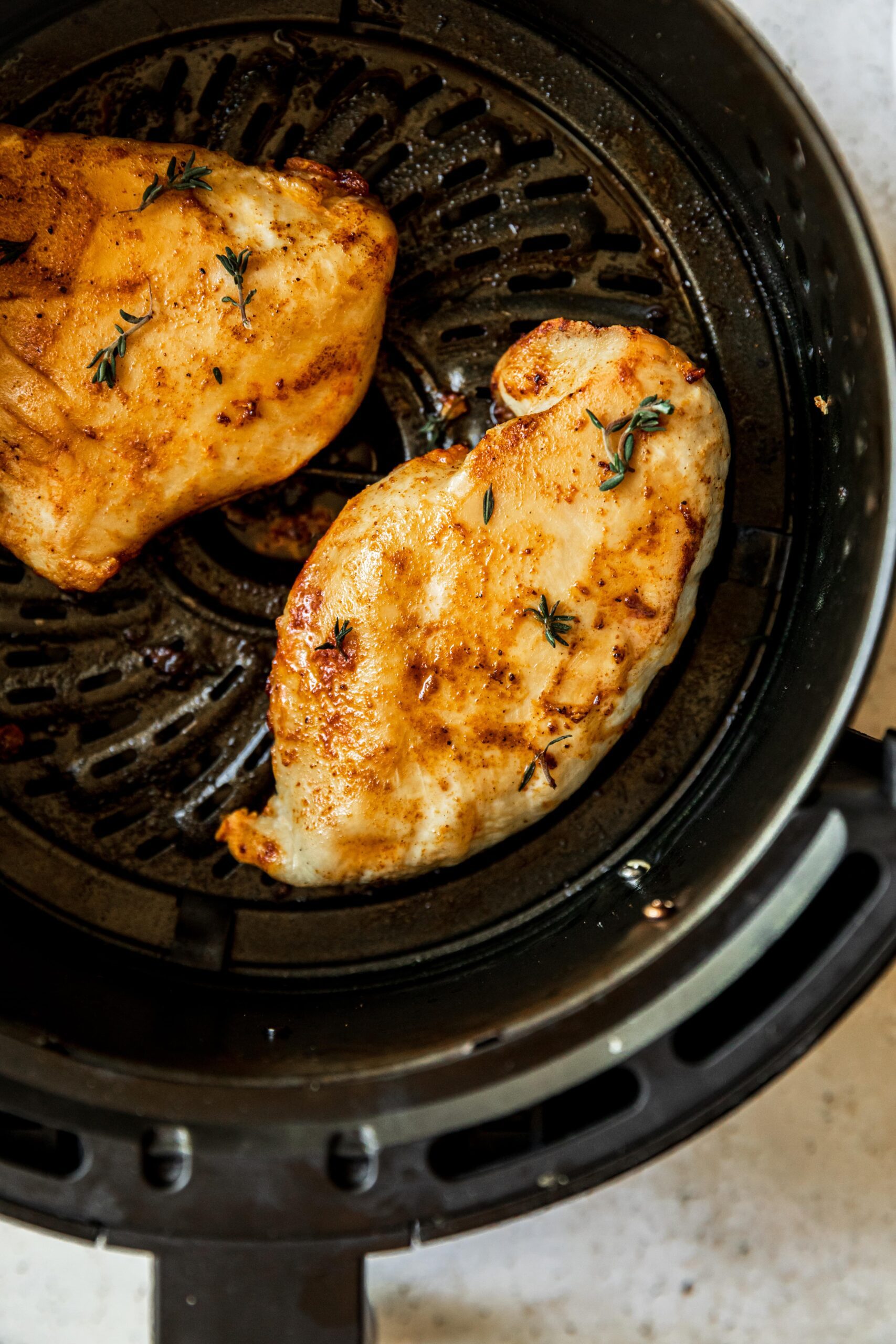 Cooked chicken breast in an air fryer.
