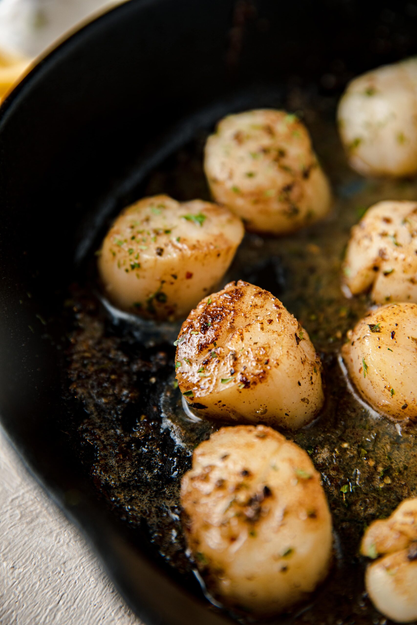 cast iron skillet with seared scallops