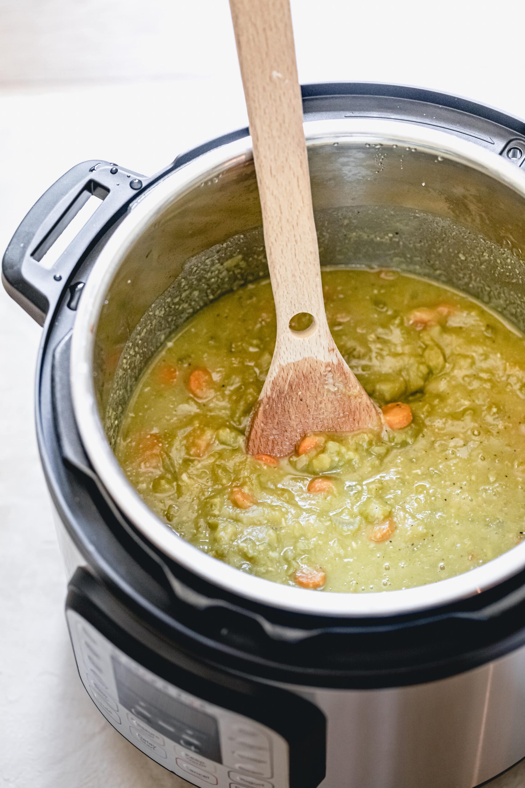 instant pot filled with cooked split pea soup
