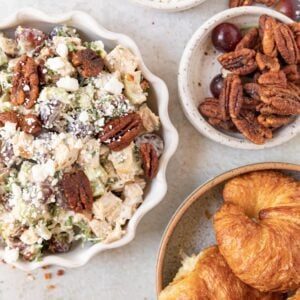 chicken salad in a bowl with croissants