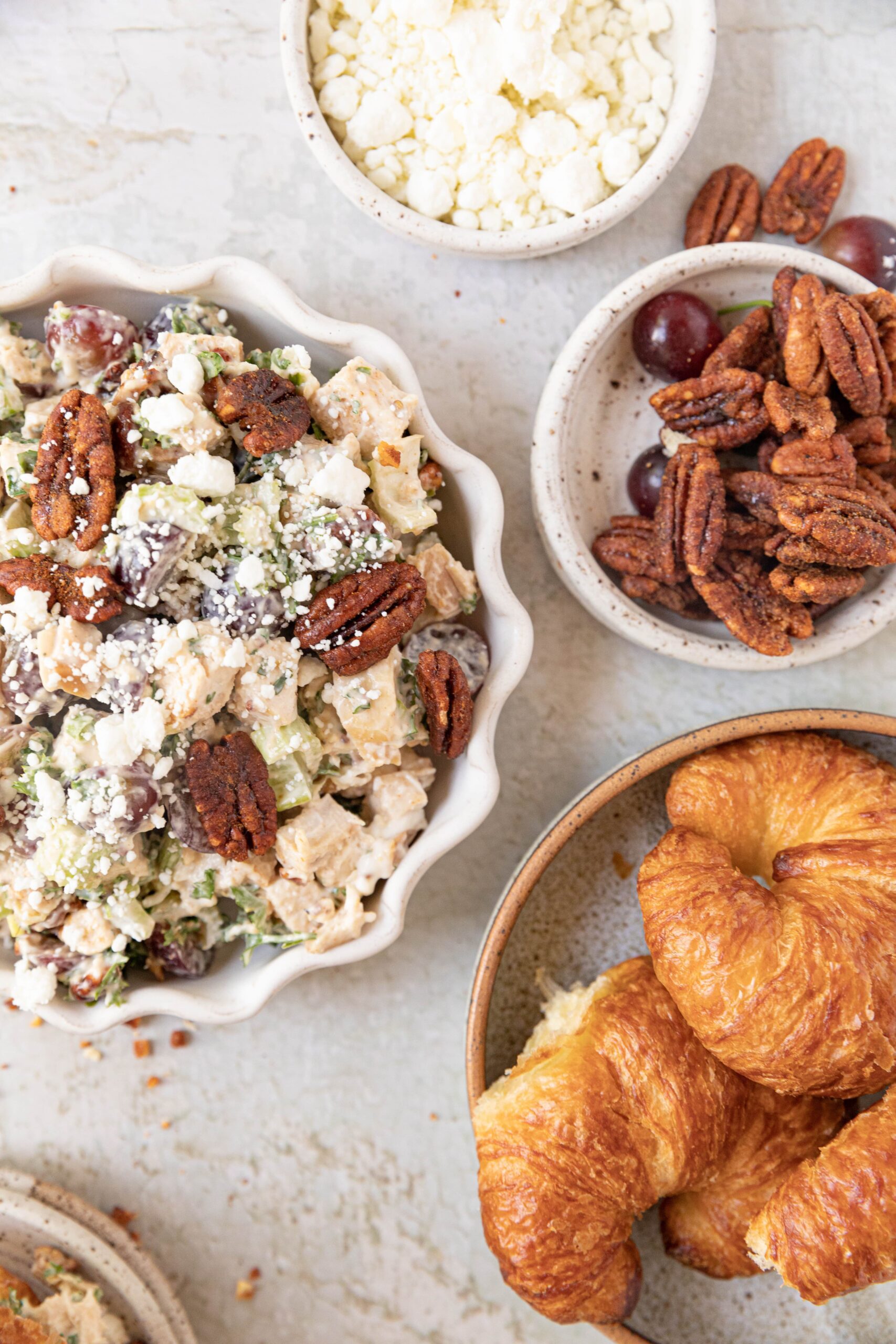 chicken salad in a bowl with croissants