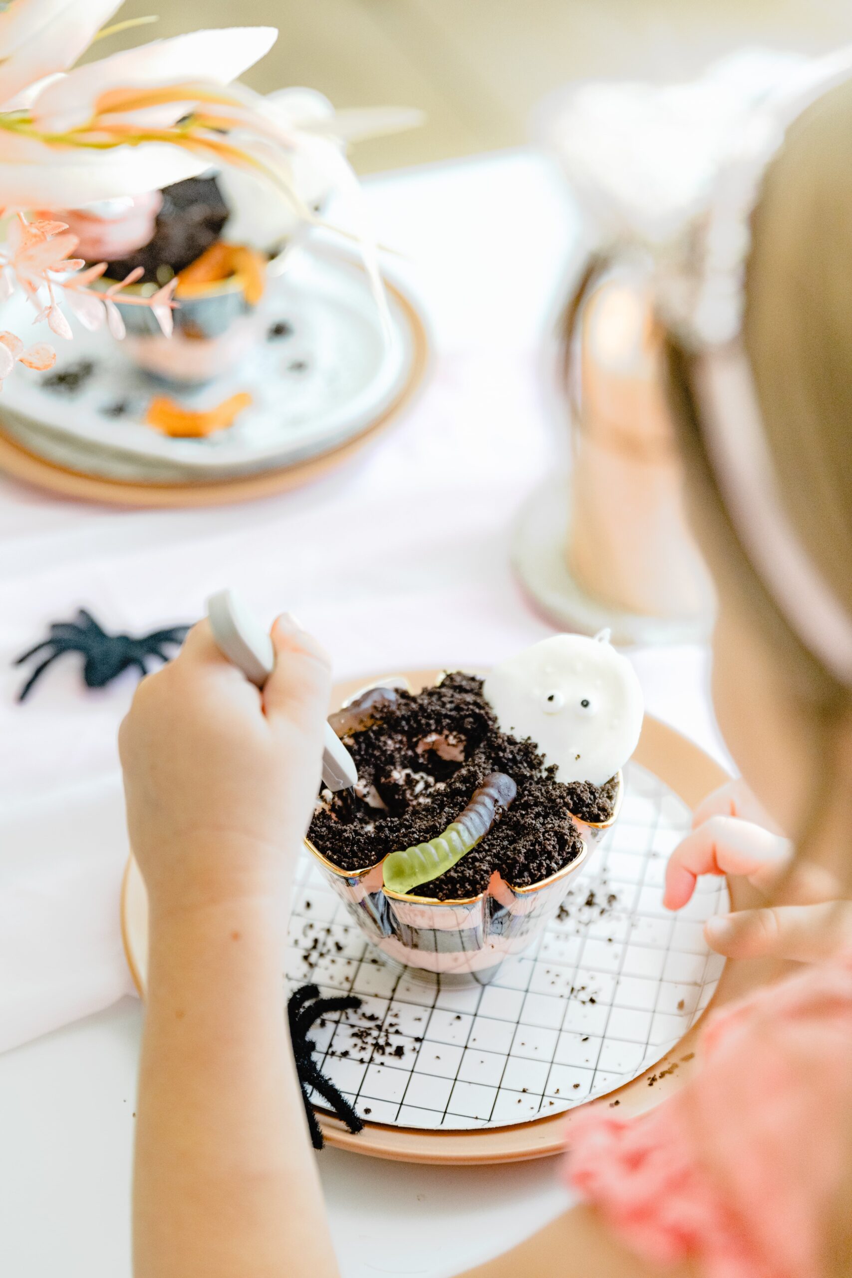 child digging into a halloween dirt cake