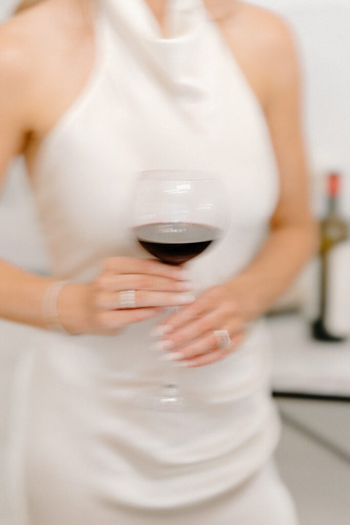Sara holding a glass of wine
