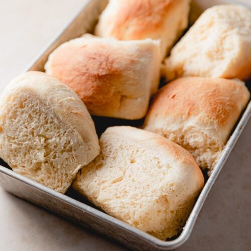 metal baking dish with dinner rolls