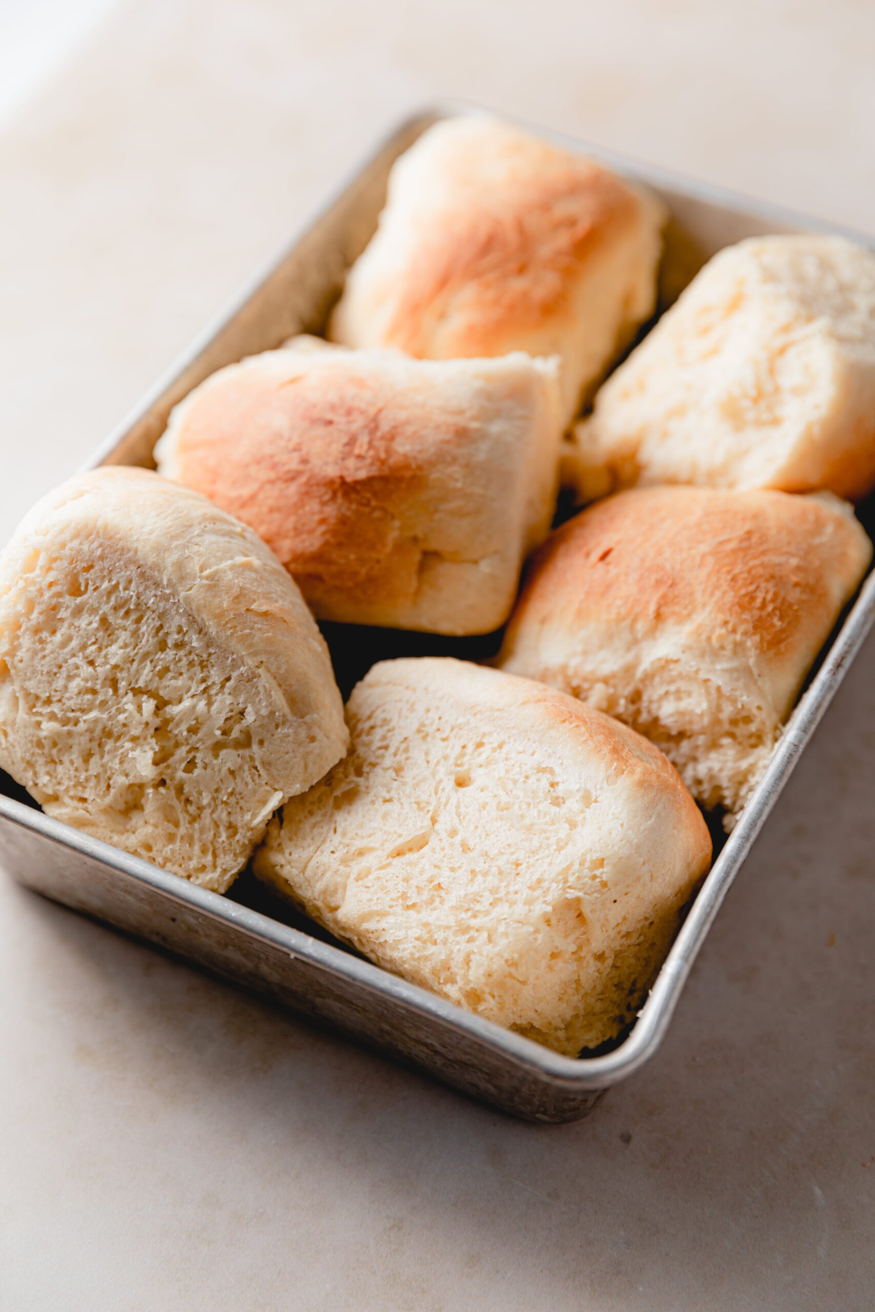 metal baking dish with dinner rolls