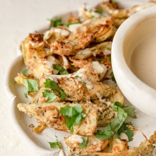 plate of artichoke hearts with a garlic aioli sauce