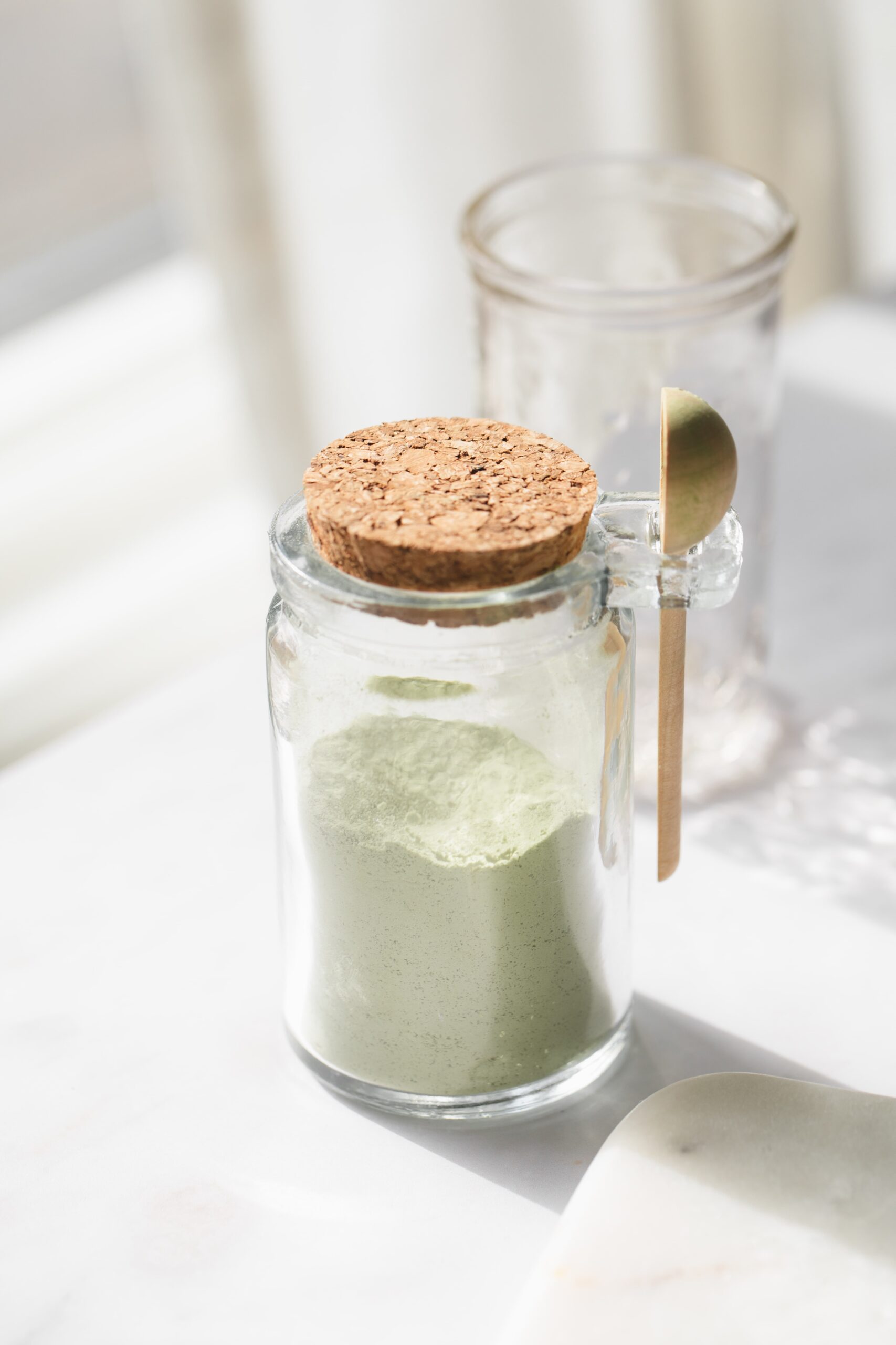 glass jar of sweetened matcha powder