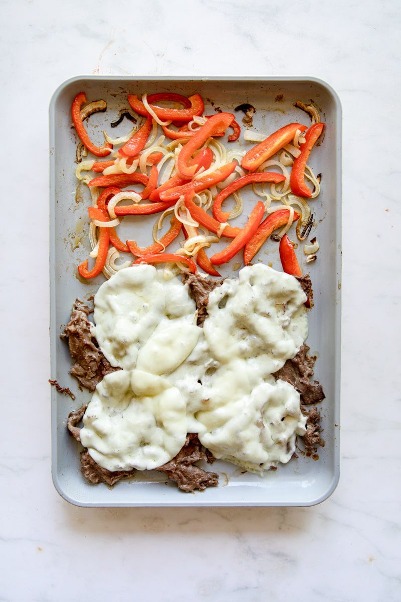 overhead photo of sheet pan Philly cheesesteak recipe after melting the cheese