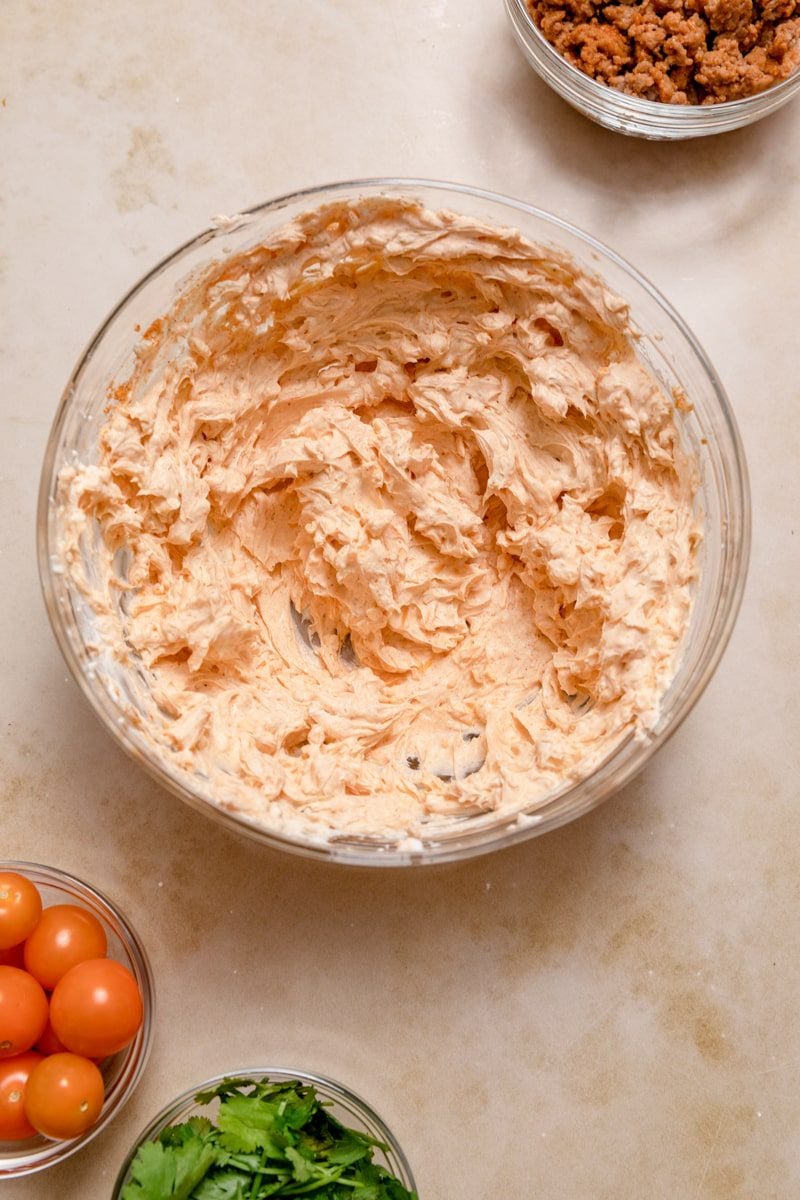 cream cheese taco dip mixture in a glass bowl