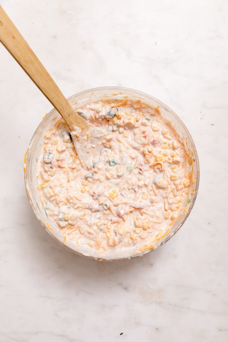 cream cheese corn dip ingredients mixed together in a bowl