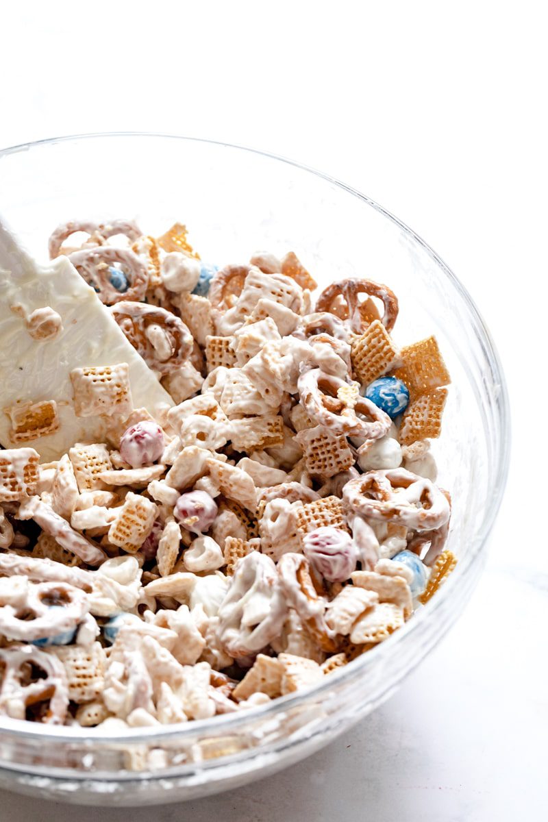 mixing bowl with snack mix, mixed with white chocolate