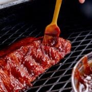brushing smoked ribs with bbq sauce