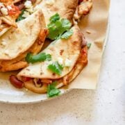 plated mini tacos on a white plate lined with parchment