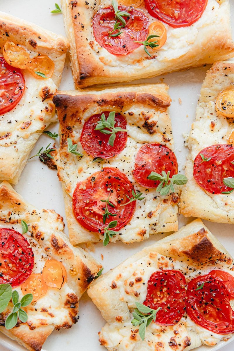 close up photo of baked tomato tarts with puff pastry
