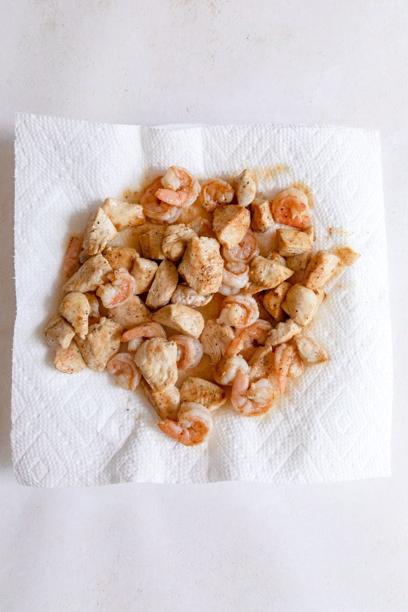 cooked chicken and shrimp on a paper towel