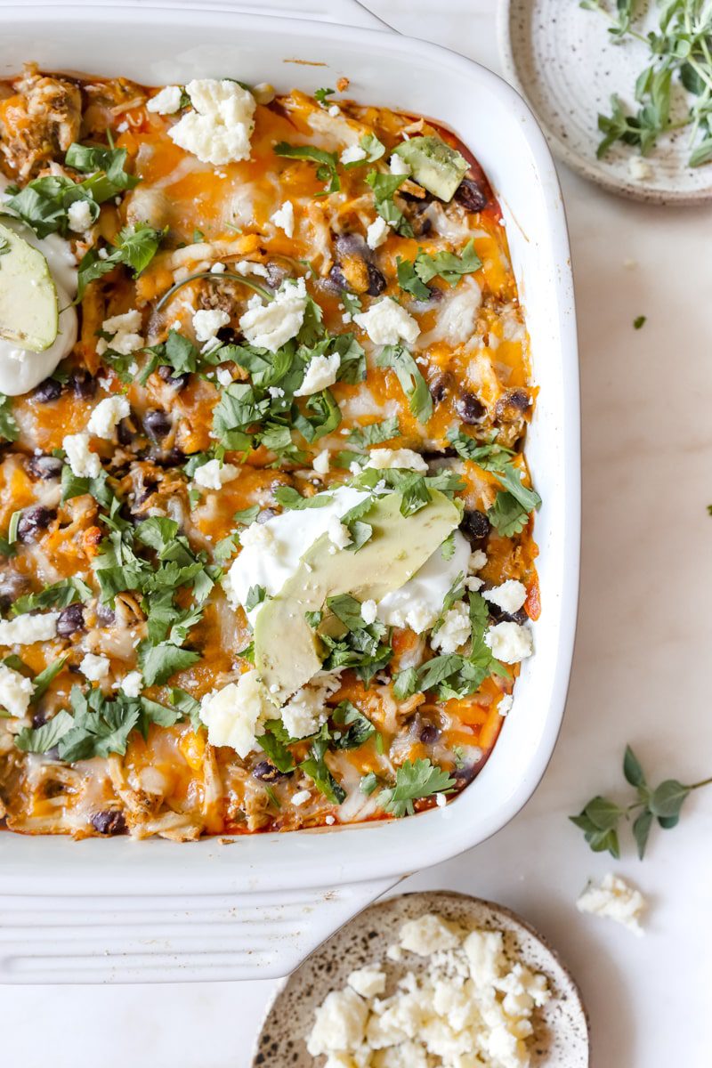 overhead photo of garnished rotisserie chicken enchilada casserole