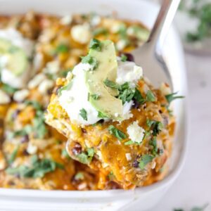 white casserole dish of chicken enchiladas