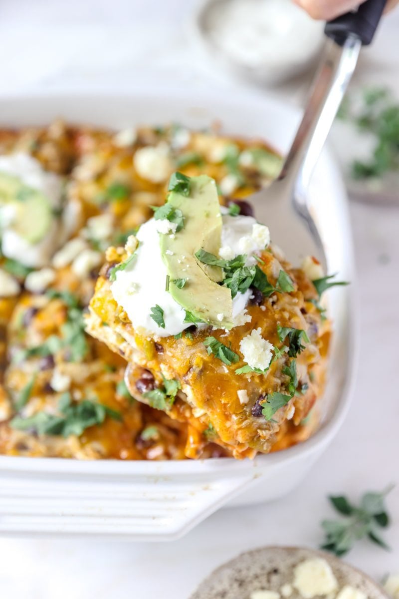 white casserole dish of chicken enchiladas
