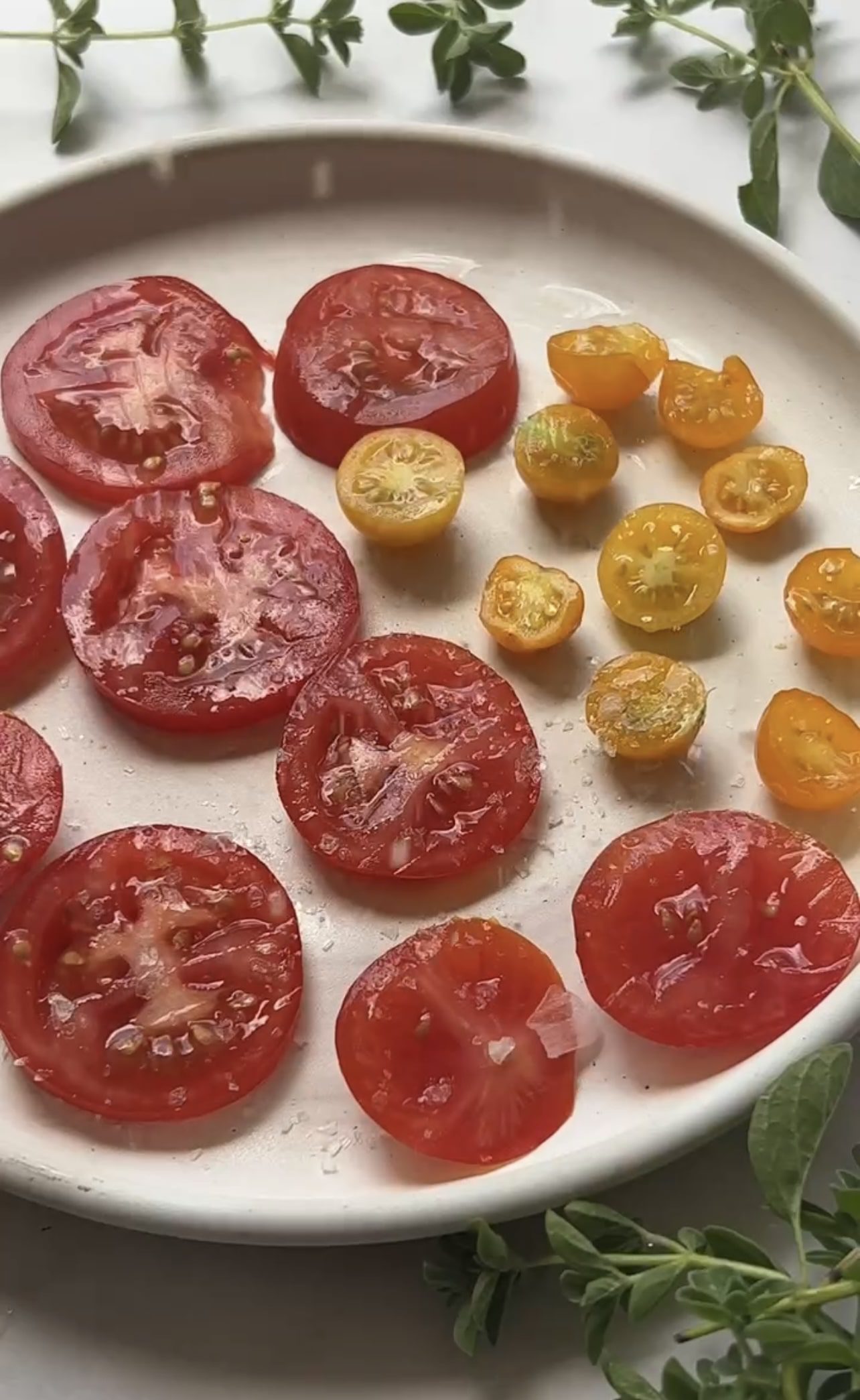 white plate of salted tomatoes