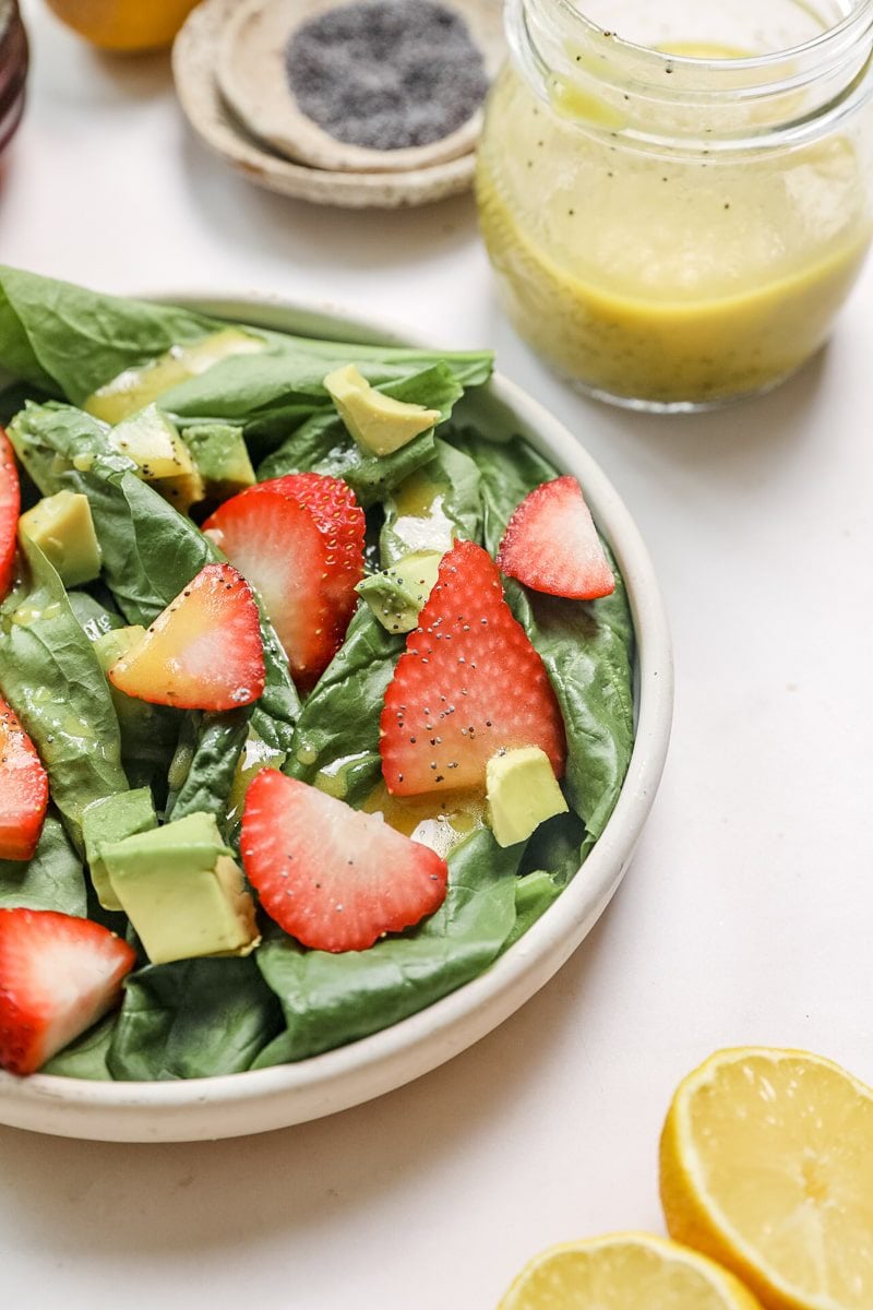 photo of spinach strawberry salad with lemon poppyseed dressing on top