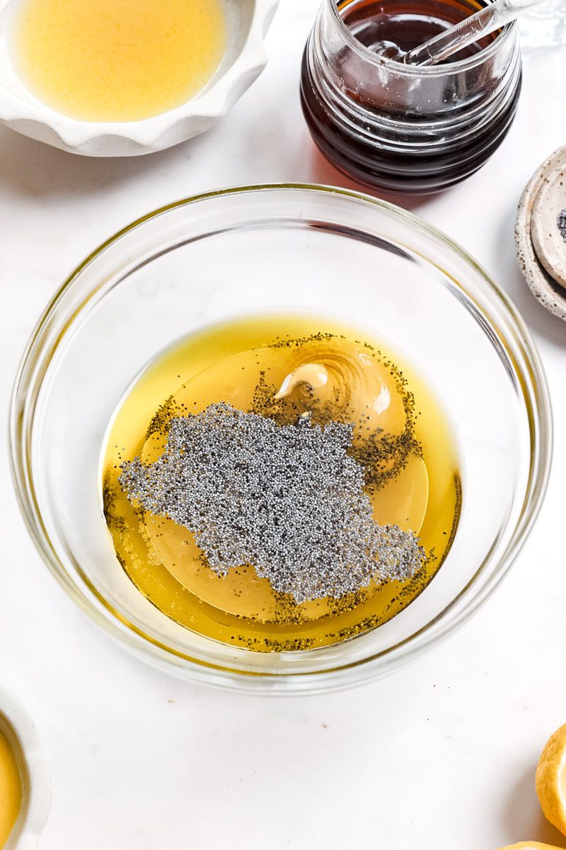 ingredients for lemon poppy seed dressing in a mixing bowl (unmixed)