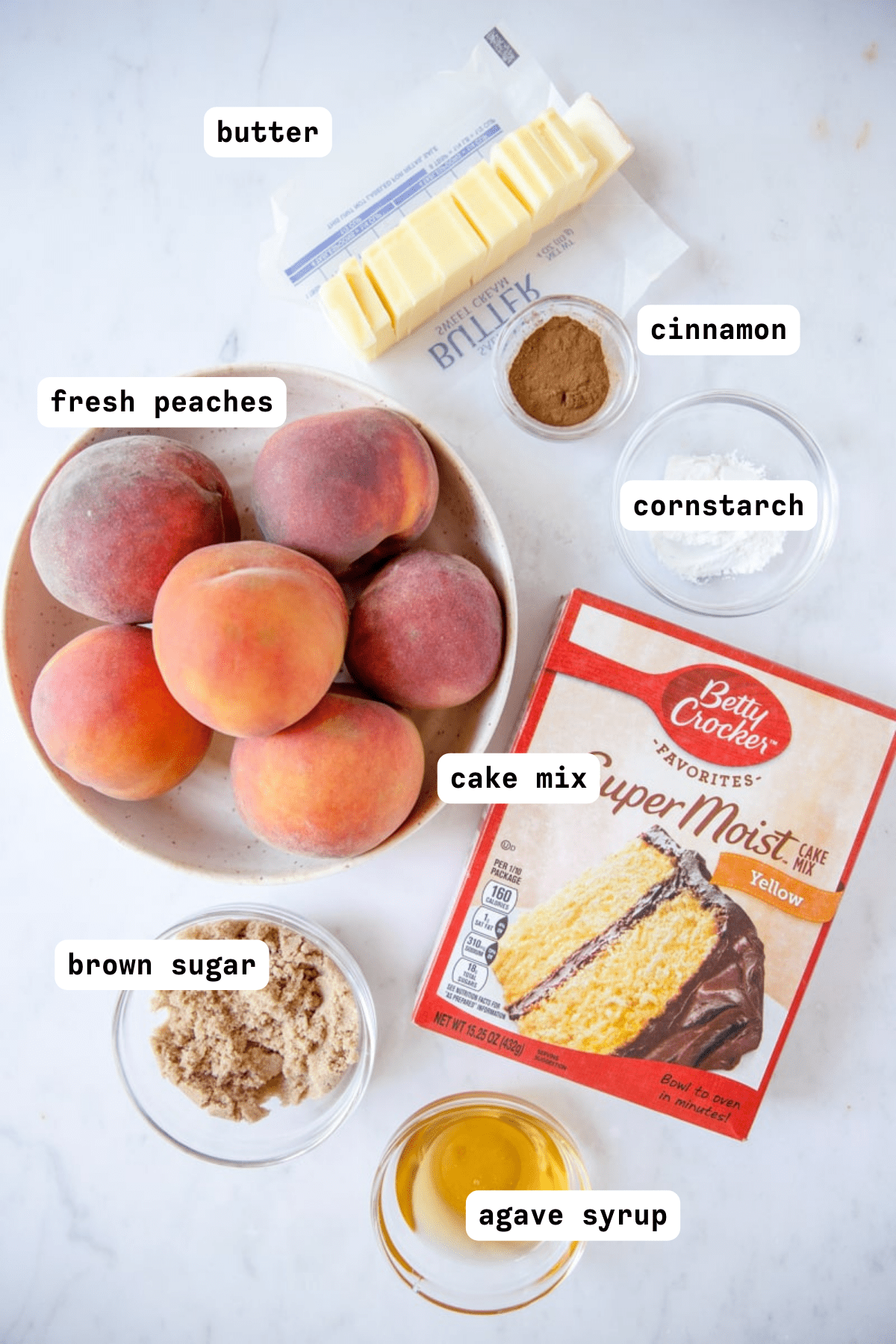 peach cobbler with cake mix ingredients layed out in a flat lay 