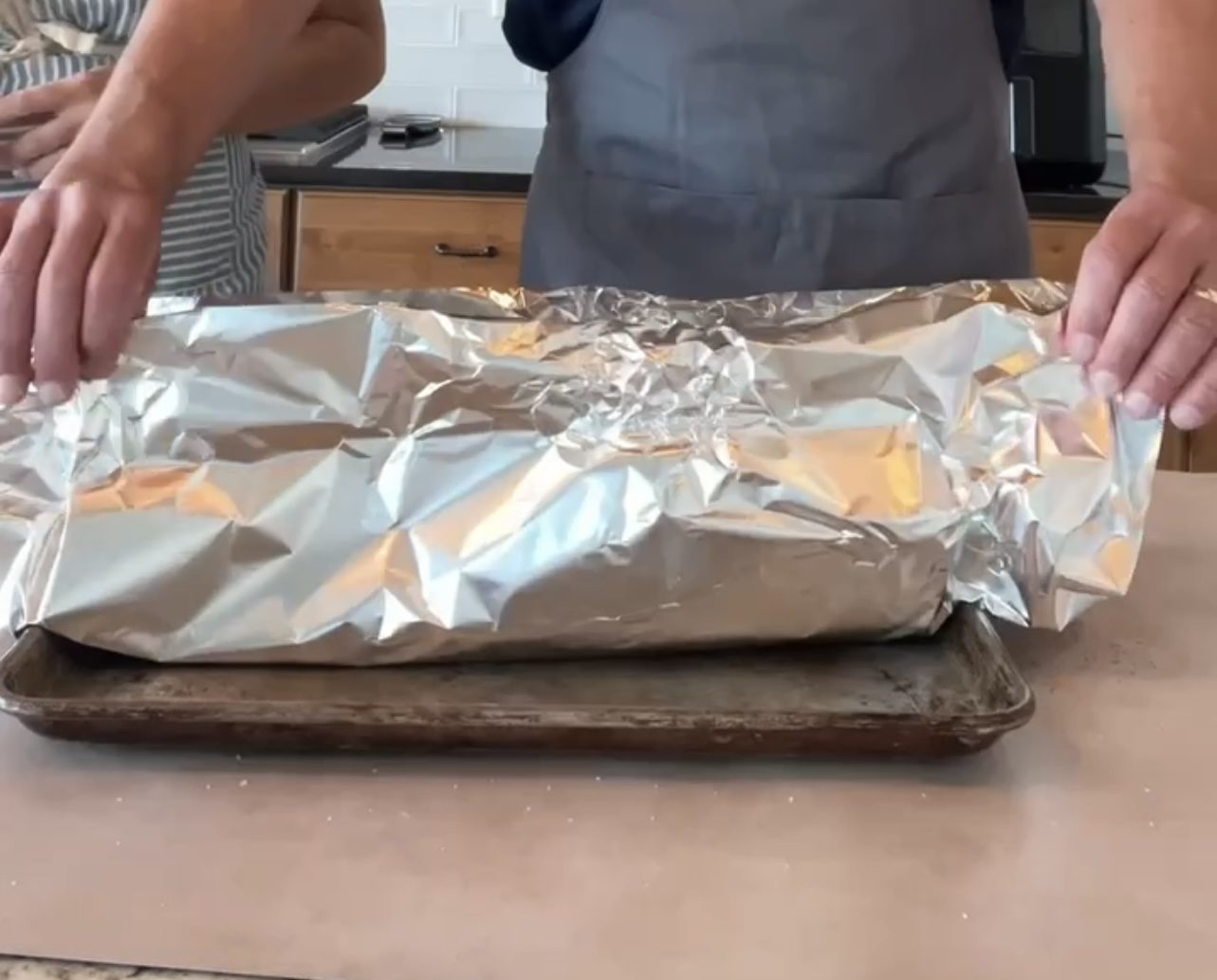 covering the rack of ribs with tin foil