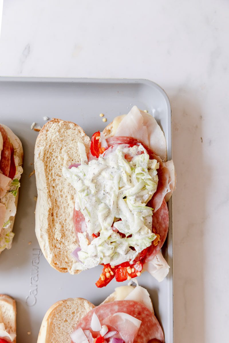 dressing on top of the italian grinder sandwiches