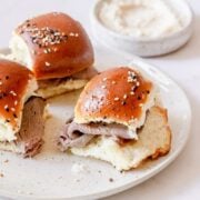 3 roast beef sliders on a white plate