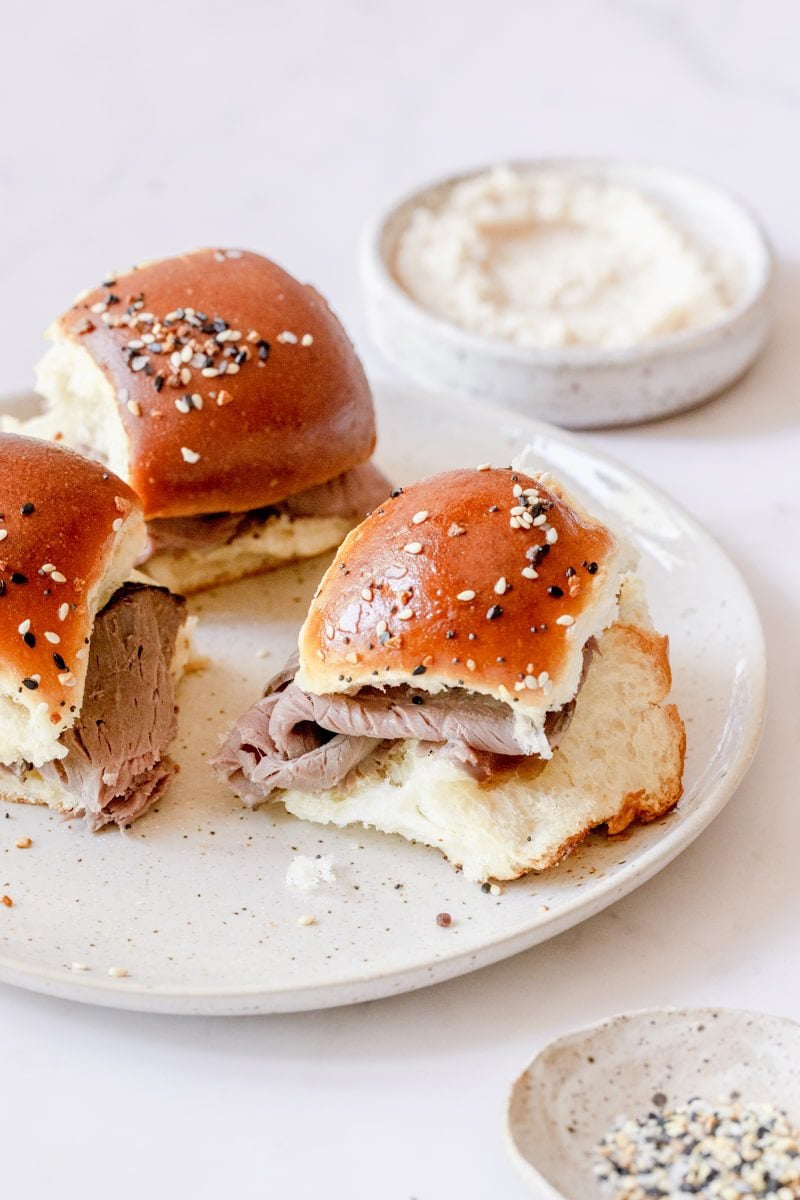 3 roast beef sliders on a white plate