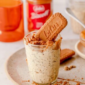 glass mason jar of biscoff overnight oats with a biscoff cookie in it