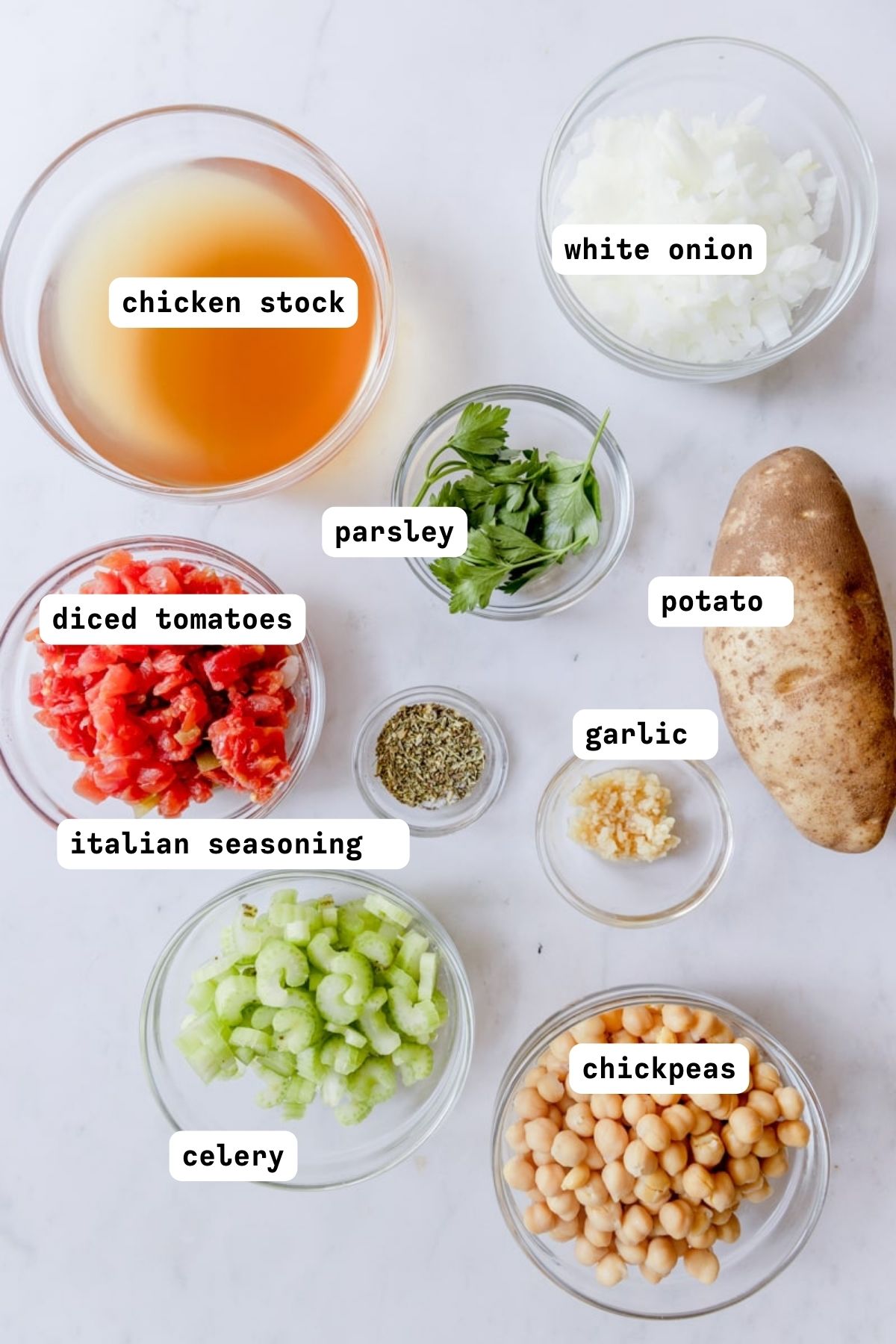 flat lay of ingredients for chickpea soup on a marble counter