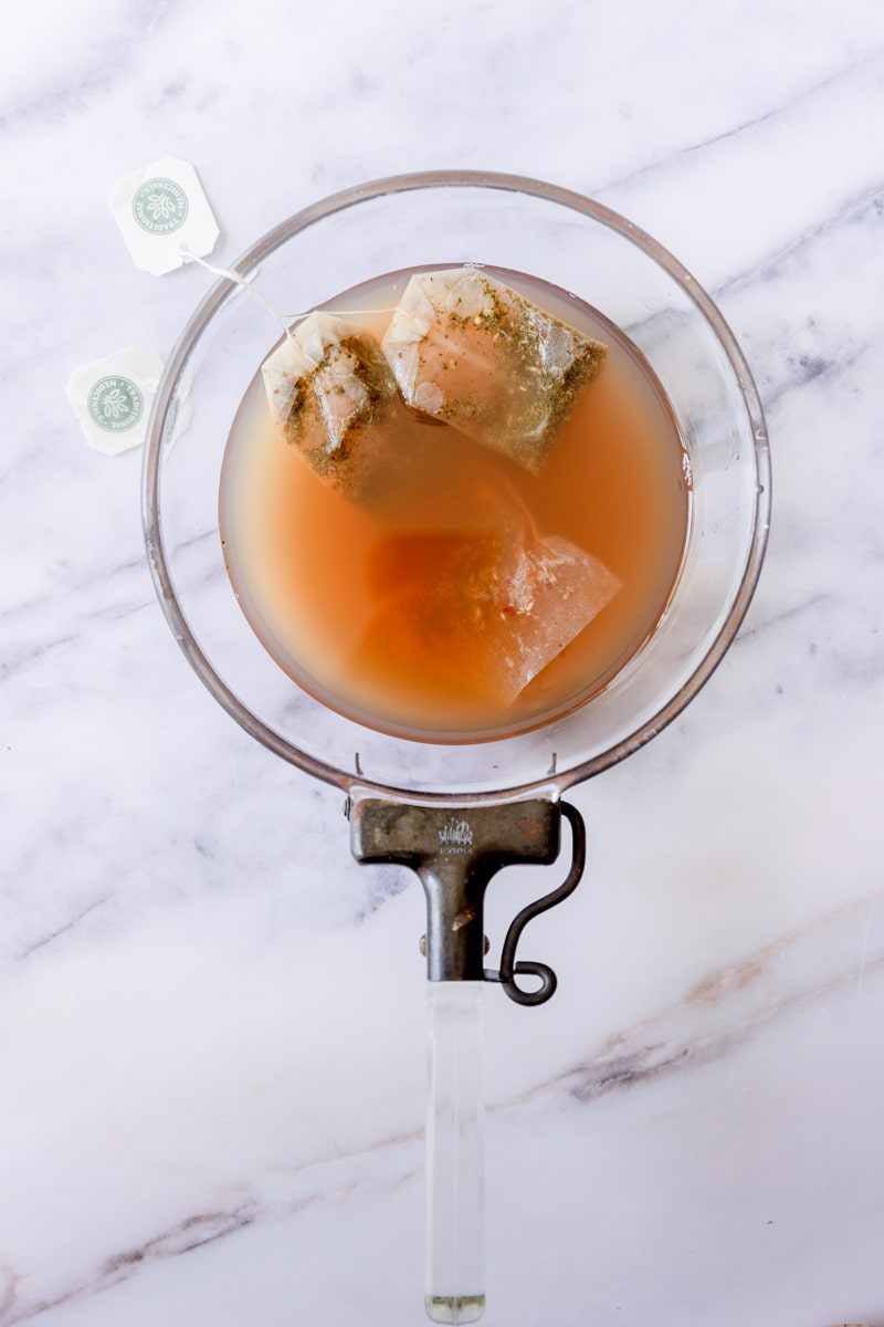 tea bags added to the saucepan of steamed lemonade