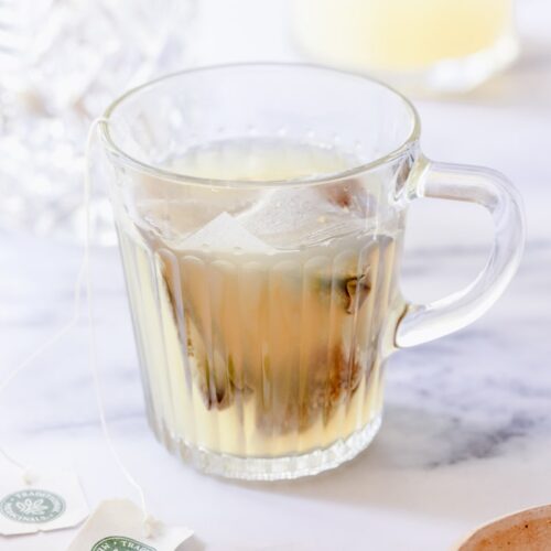 starbucks medicine ball tea in a glass cup with the teabags steeping in it
