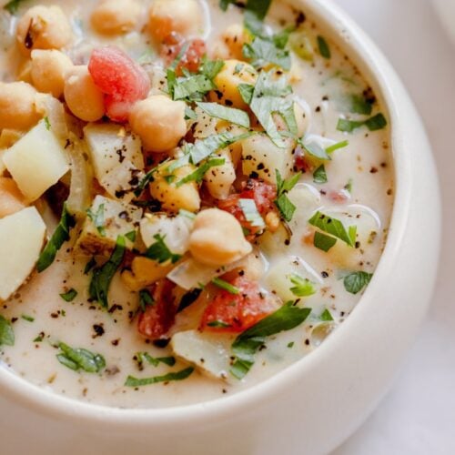 creamy italian chickpea soup served in a bowl topped with parsley