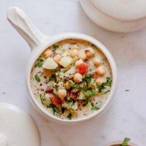 overhead photo of chickpea soup in a bowl with a handle.