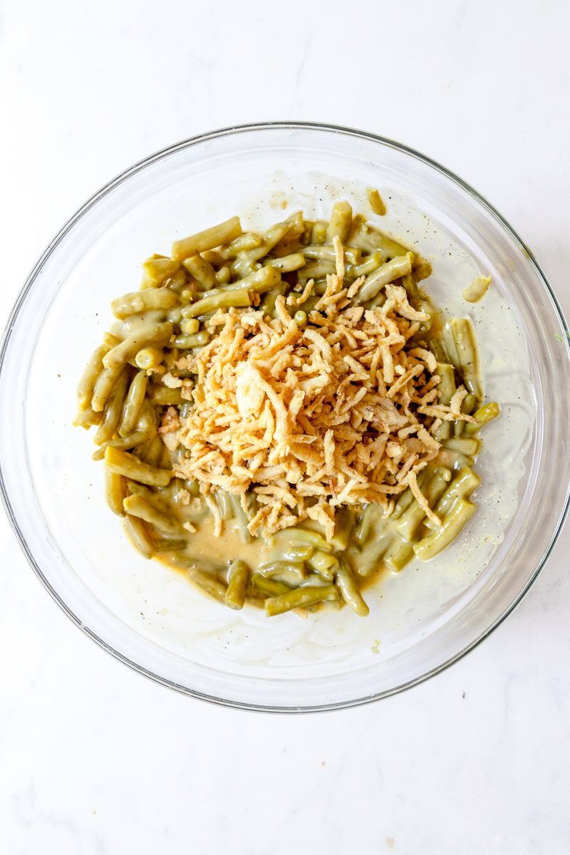 Stirring in the green beans and fried onions to the condensed soup mixture