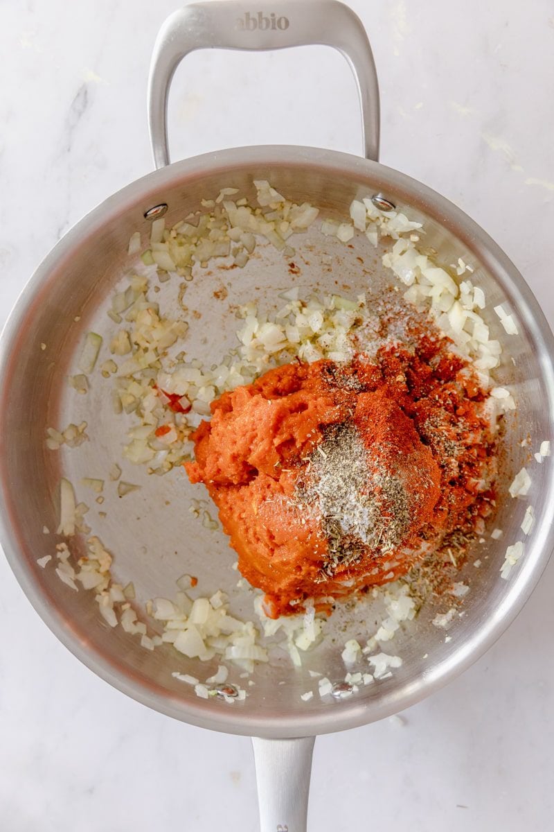 pumpkin puree added to the pan of sautéed veggies 