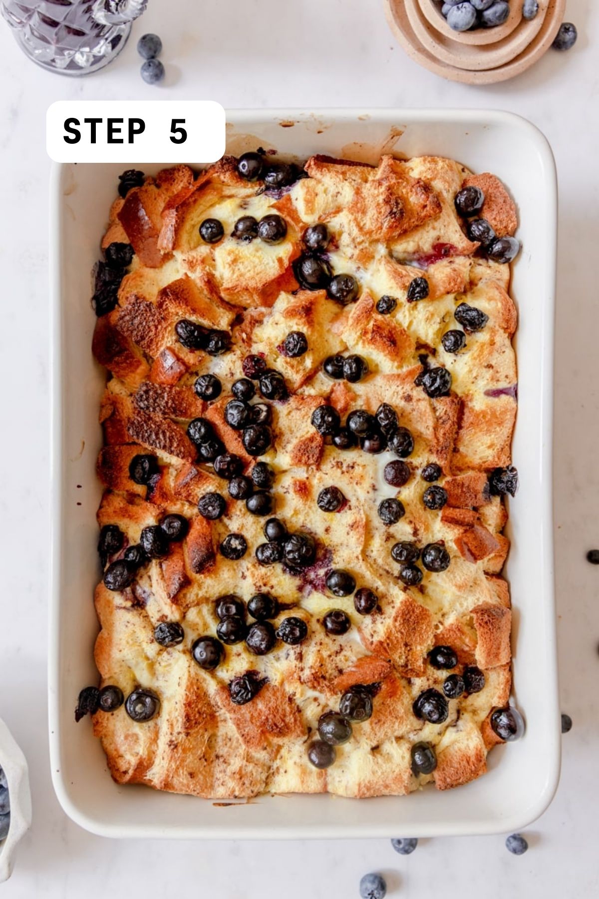 Baked brioche casserole topped with blueberries. 