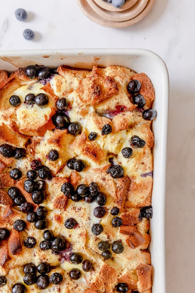 baked blueberry brioche French toast casserole topped with extra blueberries.