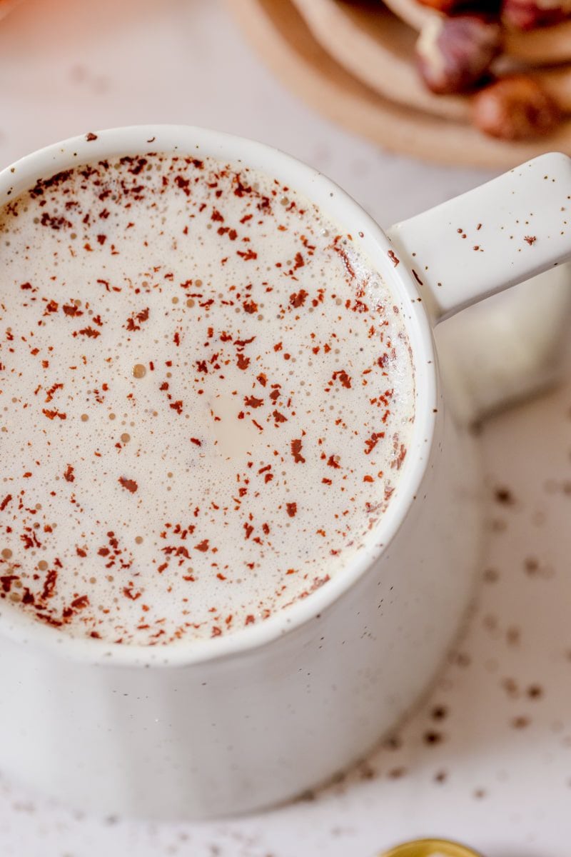 cup of hazelnut latte with chocolate shavings on top