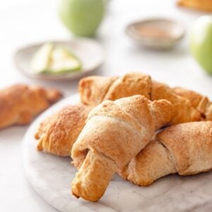 baked apple cinnamon crescent rolls on a plate.