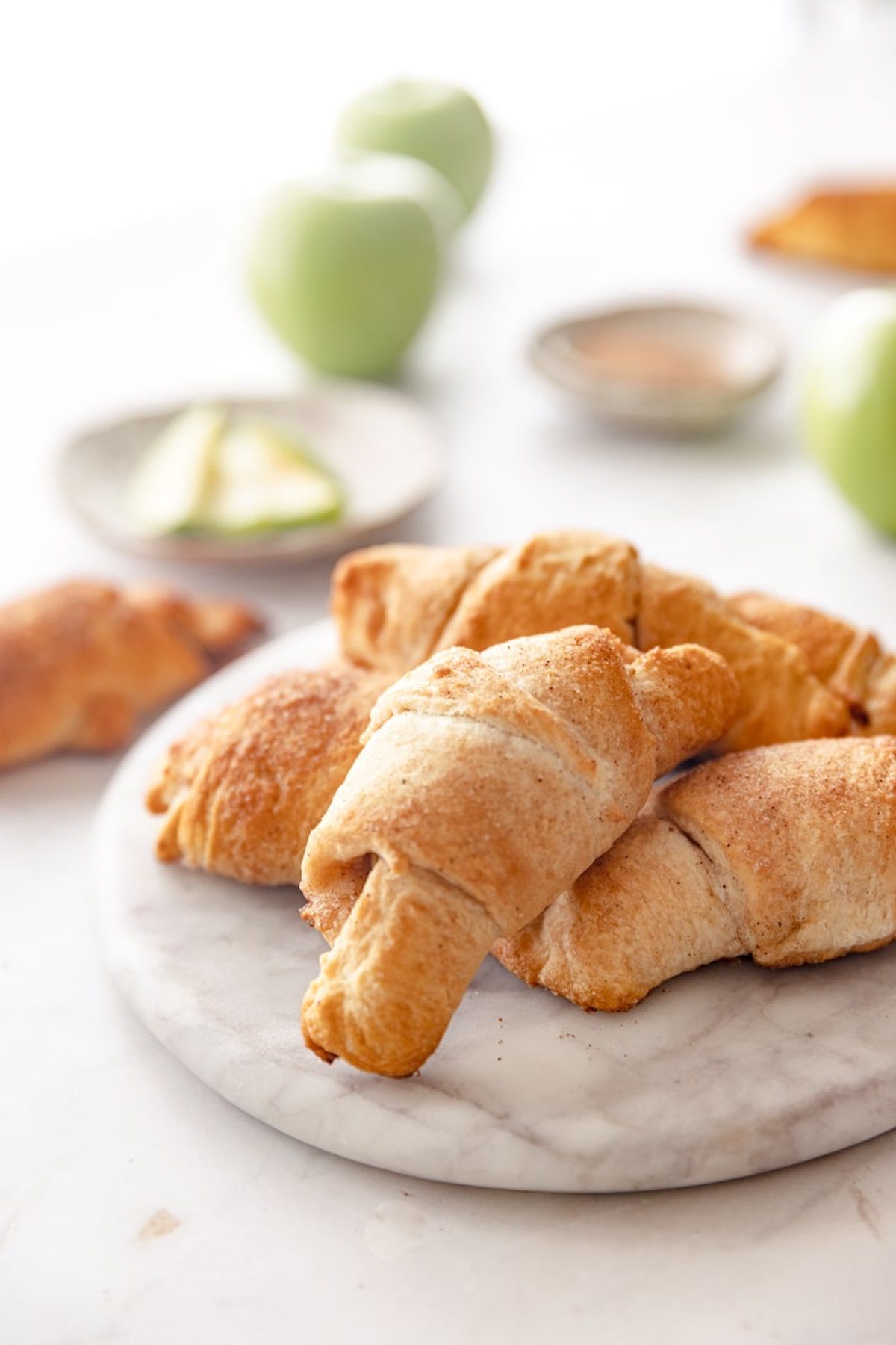 baked apple cinnamon crescent rolls on a plate.